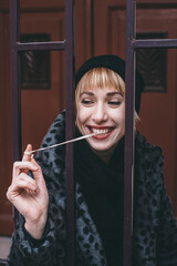 Portrait of laughing young woman with chewing gum