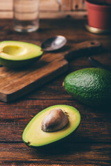Green whole and halved avocados