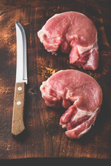 Two pork loin steaks with knife