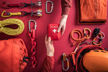 Overhead view of woman handing over first aid kit to man with climbing equipment in background