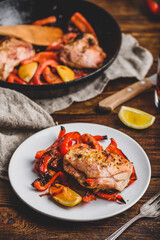 Baked chicken thighs with red bell peppers and lemon