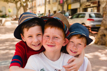 Group picture of three happy boys on holiday