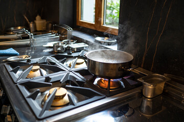 Cooking pot on gas stove in restaurant kitchen