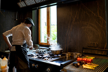 Chef preparing grilled vegetables in restaurant kitchen