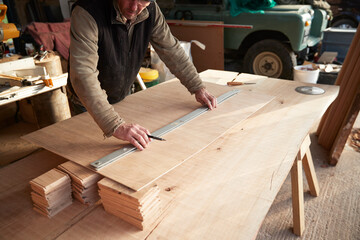 Worker measuring wood