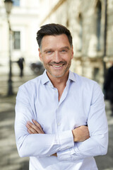 Portrait of smiling businessman in the city