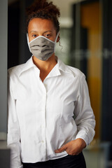 Portrait of businesswoman wearing homemade protective mask