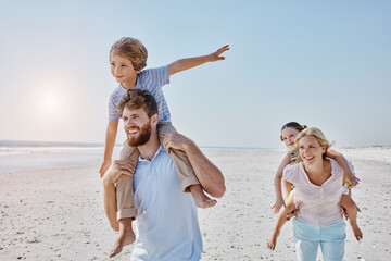 Happy family strolling on the beach