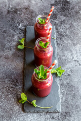 Beet root smoothie in glasses garnished with fresh mint