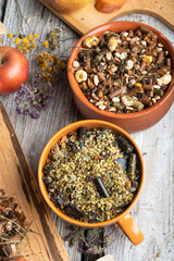 special muesli and granules for sportive horses  served in bowls around muesli background.  feeding and horse care concept.