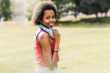 Portrait of smiling sporty young woman in park