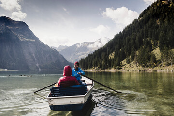 Austria, Tyrol, Alps, couple in rowing boat on mountain lake