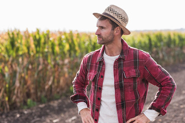 Farmer standing on field looking sideways