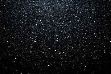 Snowy night sky. White dots on a dark background. Winter.
