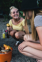 Two happy young women having a barbecue