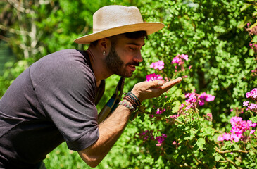 Man smelling flowers in garden