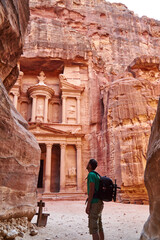 Backpacker admiring the Al-Khazneh in Petra, Jordan