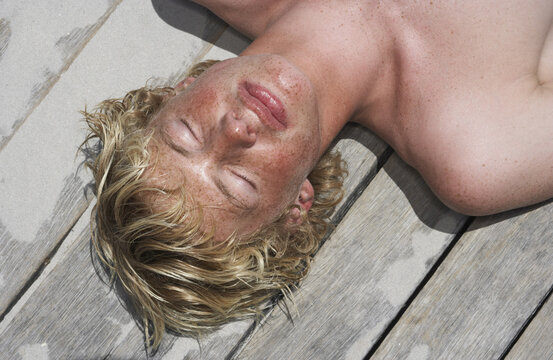 Young Man Lying On Deck