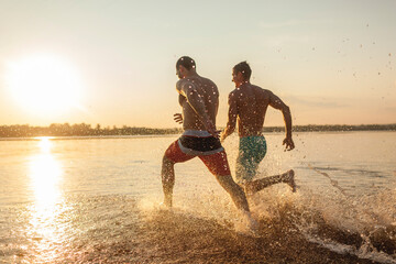 Two friends running in water