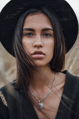 Portrait of fashionable young woman wearing black hat - obrazy, fototapety, plakaty