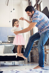 Father balancing his daughter on his foot