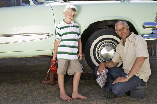 Portrait of Family Fixing Car