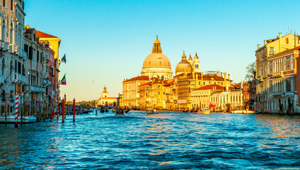 Grand canal at sunset, with view of the basilica Santa Maria delle Salute, Italy. Romantic view on canale grande, Venice, Italy at sunset. - obrazy, fototapety, plakaty
