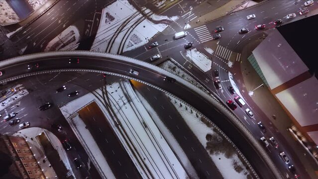 Overhead Night View of Snowy Urban Traffic
