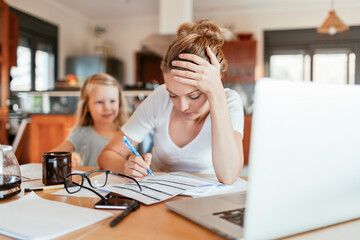 Stressed Mother Managing Finances and Work with Child at Home