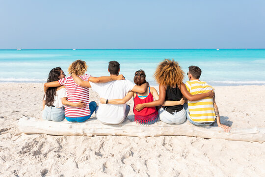 Friends taking a break, sitting on the beach