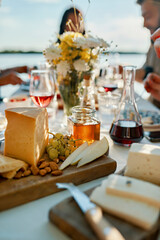 Cheese platter on table with people in background