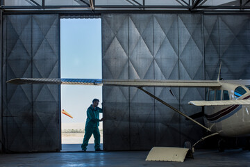 Mechanic opening hangar gate