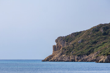 Sandy beach by the sea near Agios Georgios on the island of Corfu under a blue sky