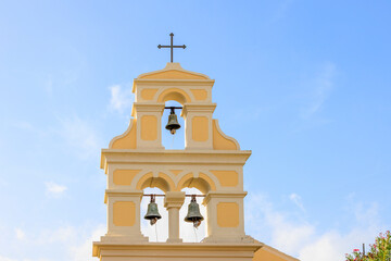 Bell tower of the Greek Orthodox Church in Sidari on the island of Corfu under a blue sky