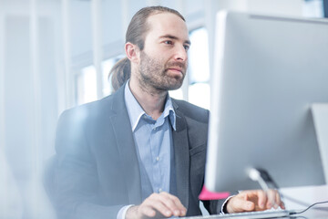 Businessman in office working on a computer