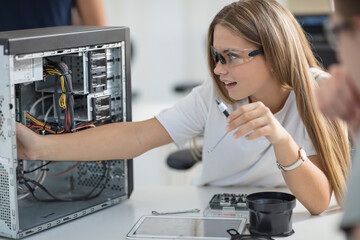 Students assembling computer in class