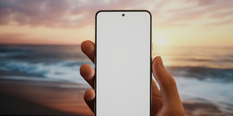 CU Caucasian man using his phone on ocean shore, blank screen mockup
