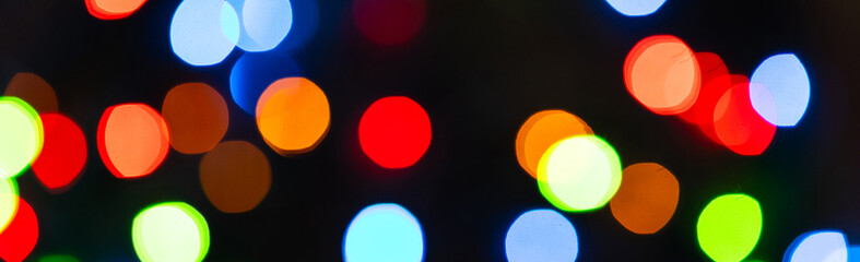 Banner. Colourful festive bokeh lights on background. Abstract multicolored light. Christmas or New Year holiday concept. Mock up template for greeting card