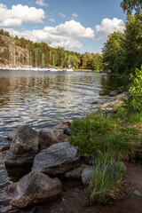 Sweden. Rocky lake shore under a cloudy sky on a summer day