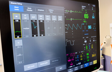 Hospital monitors display vital signs: hemodynamics, heart rate, blood pressure, temperature, oxygen saturation, and end-tidal CO2 for patient health assessment