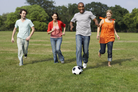 Friends Playing Soccer Outdoors