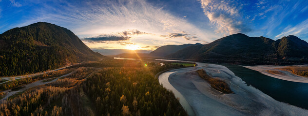 Scenic River in the Valley, surrounded by Mountains. Sunset. Aerial Landscape.