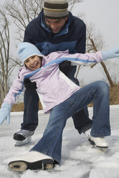 Father Catching Daughter while Skating