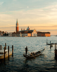 venezia venice Italy city. Small boat in the foreground cruising towards the church during clean...