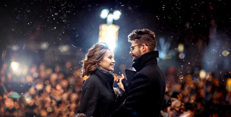 couple in love joyfully on a date in winter on stage