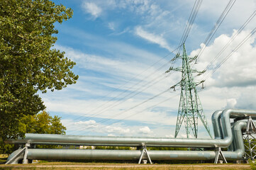 pipeline and power lines against the blue sky - obrazy, fototapety, plakaty