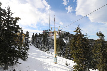 Ski Lift snowy mountain winter forest with chair lift At The Ski Resort in winter. Snowy weather Ski holidays Winter sport and outdoor activities Outdoor tourism, Bursa (Turkey), Uludağ ski lift