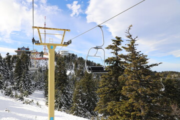 Ski Lift snowy mountain winter forest with chair lift At The Ski Resort in winter. Snowy weather...