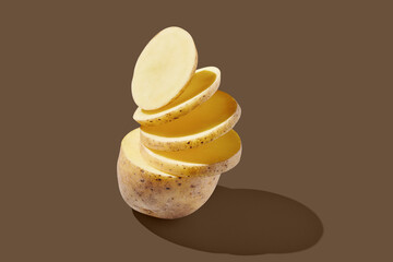 Potato slices on brown pastel background