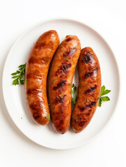 Grilled sausages on the white plate on white isolated background